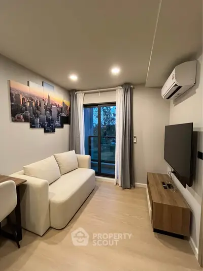 Modern living room with cityscape art, cozy sofa, and wall-mounted TV.