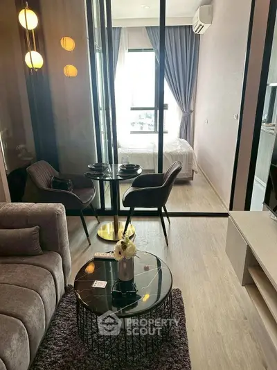 Modern living room with cozy seating and elegant decor in a stylish apartment.