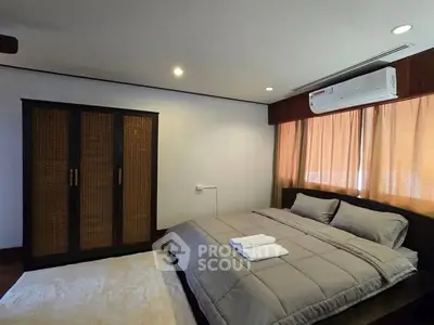 Cozy bedroom with modern furnishings and air conditioning