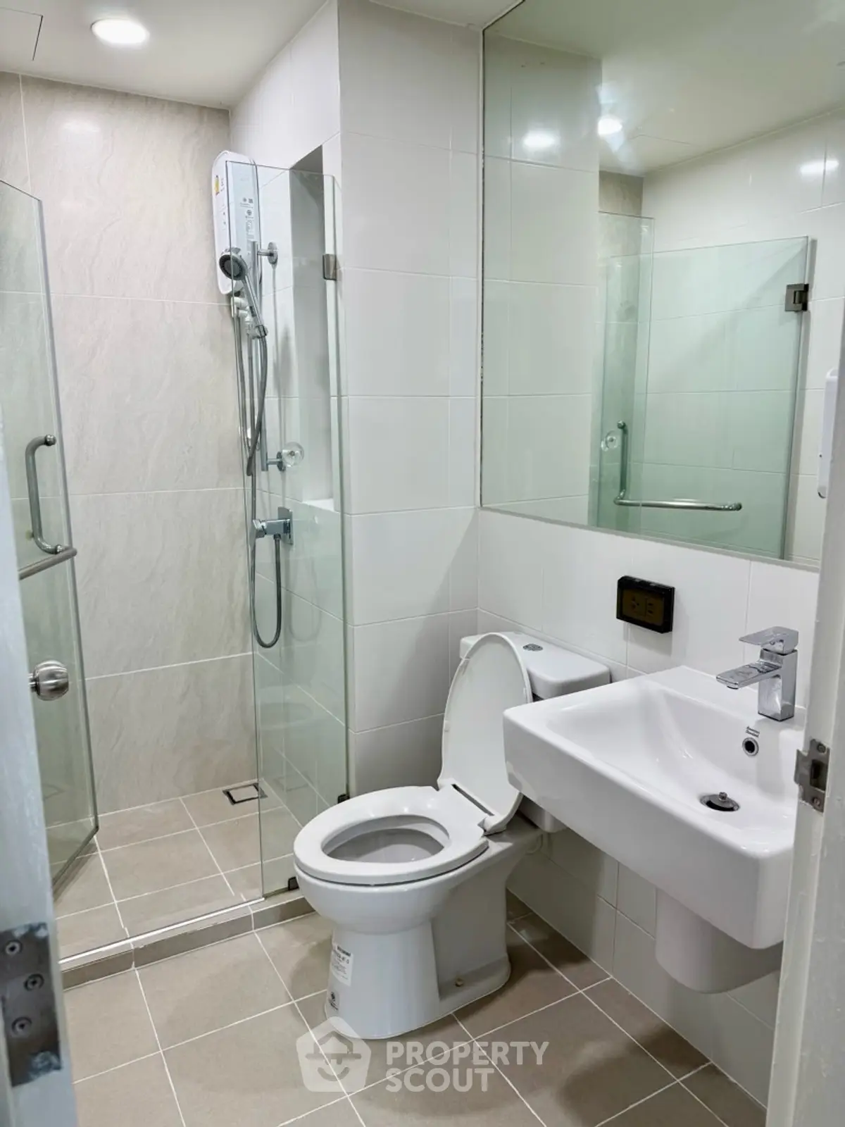 Modern bathroom with glass shower and sleek fixtures in a contemporary apartment.