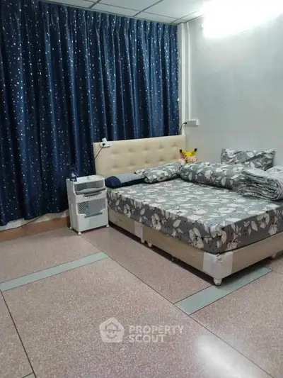 Cozy bedroom with floral bedding and starry curtains, perfect for restful nights.