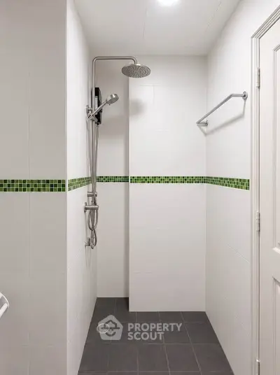 Modern bathroom with sleek shower and stylish green tile accents
