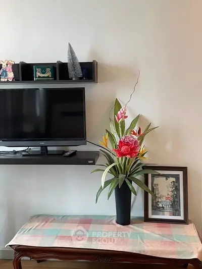 Charming living room with modern TV setup and elegant floral decor