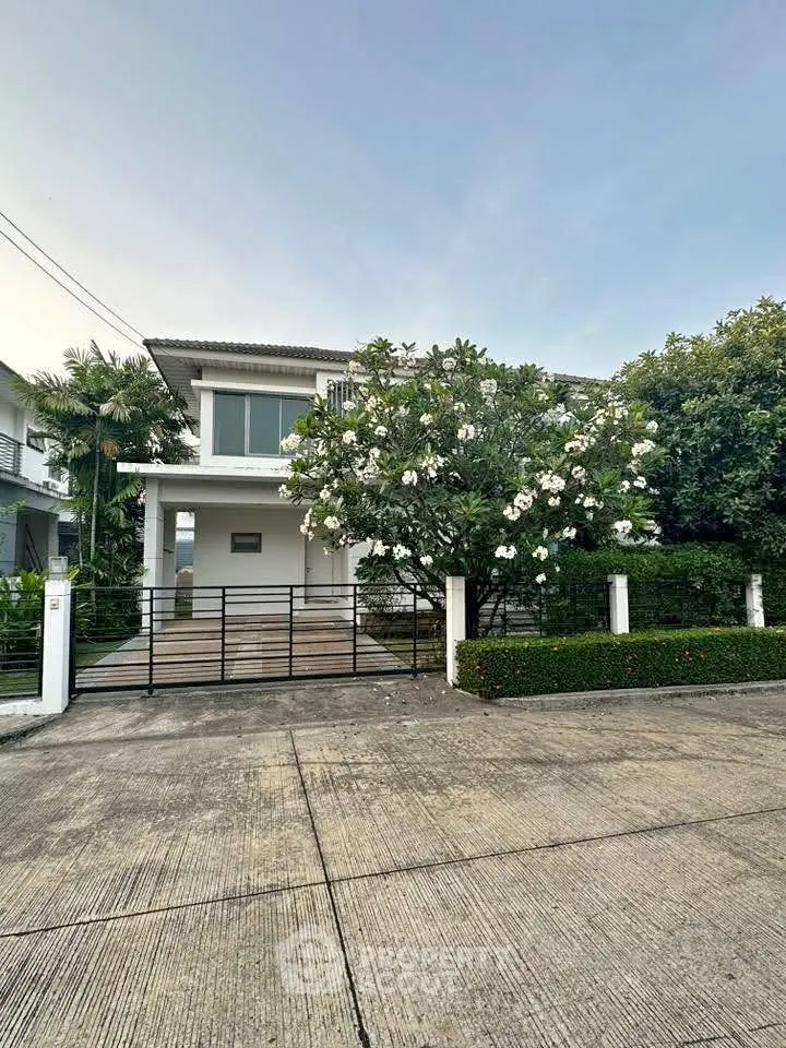 Charming two-story house with lush garden and modern design in a serene neighborhood.
