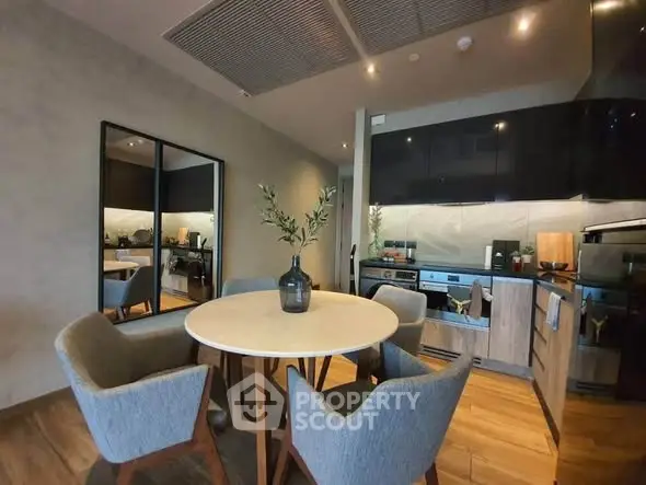 Modern kitchen with dining area featuring sleek design and cozy seating
