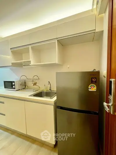 Modern kitchen with sleek cabinets and stainless steel fridge