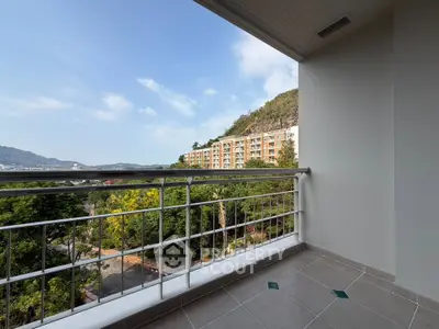 Spacious balcony with stunning mountain and city views, perfect for relaxation and enjoying nature.