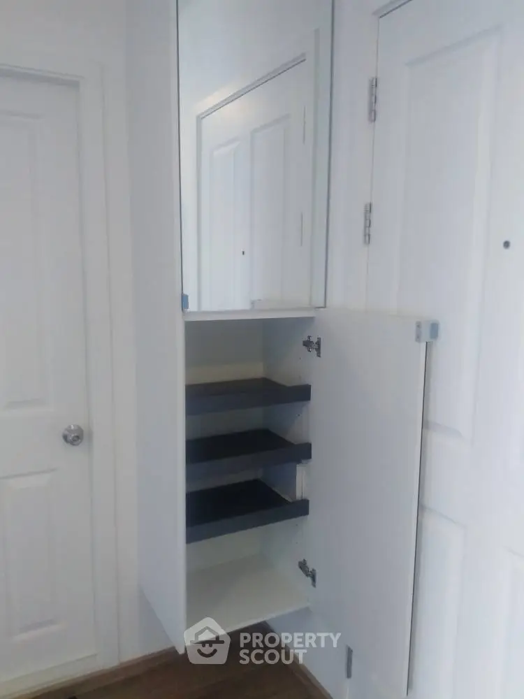 Modern interior with sleek white storage cabinet and mirrored door
