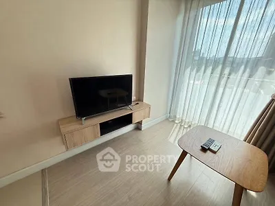 Modern living room with sleek TV setup and natural light