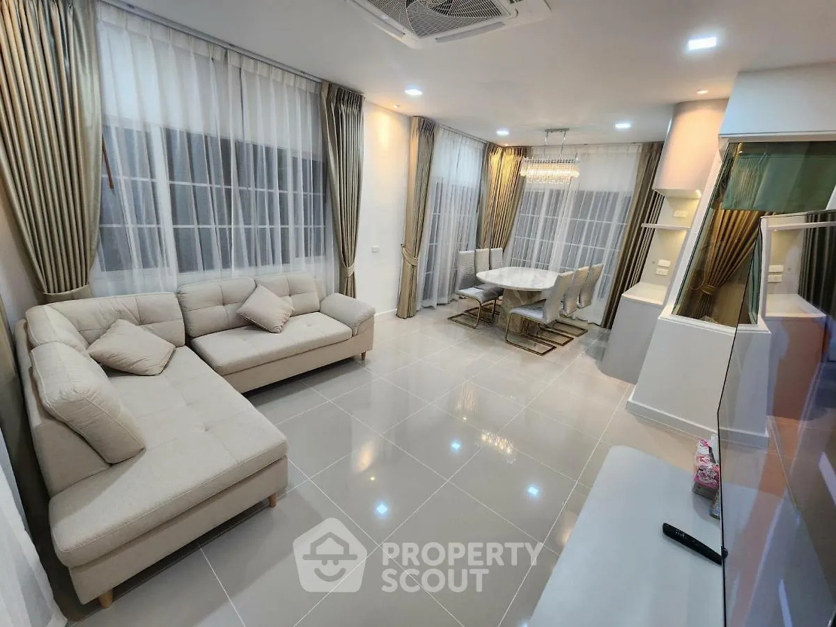 Spacious modern living room with elegant dining area and large windows