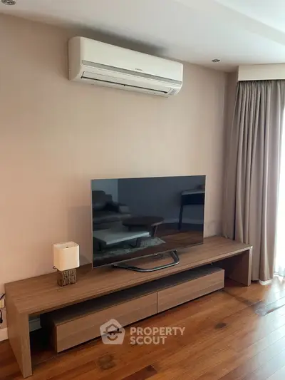 Modern living room with sleek TV setup and air conditioning