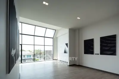 Spacious modern living room with large windows and elegant decor