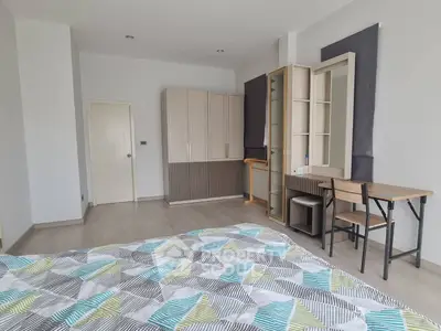 Spacious bedroom with modern decor and ample natural light