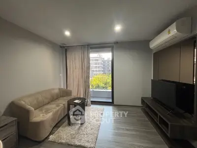 Modern living room with sleek furniture and balcony view in a stylish apartment.