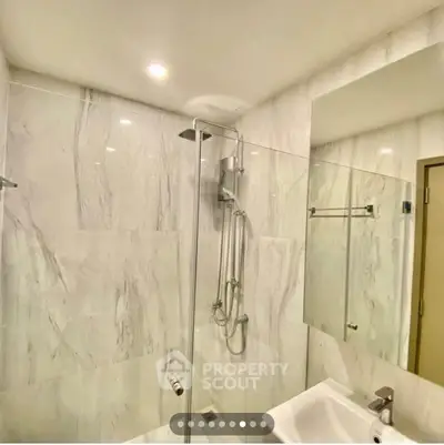 Modern bathroom with sleek shower and elegant marble walls