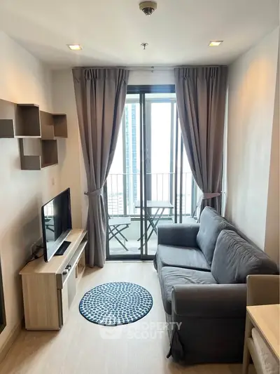 Cozy living room with modern decor and balcony view in a high-rise apartment.