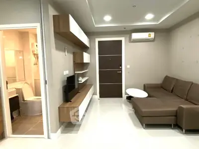 Modern living room with sleek furniture and open bathroom view