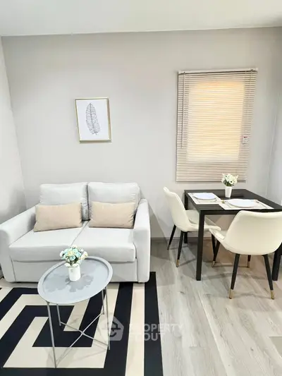 Modern living room with cozy sofa and elegant dining area in stylish apartment.