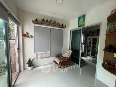 Cozy living room with rocking chair and modern decor, perfect for relaxation.