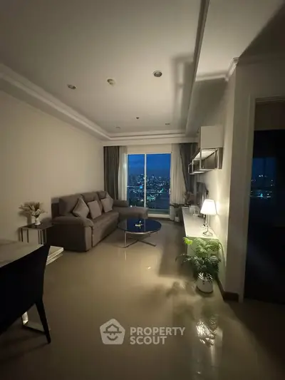 Elegant living room with city view, cozy sofa, and ambient lighting.