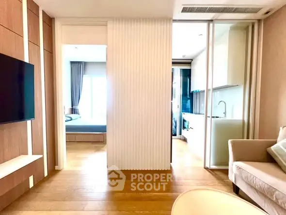 Modern apartment interior with open layout, featuring living room, kitchen, and bedroom.