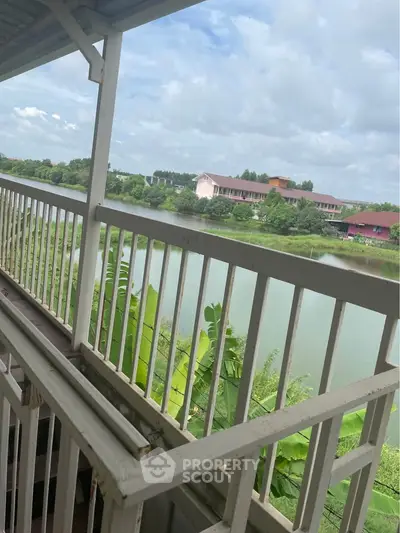 Stunning balcony view overlooking serene lake and lush greenery.