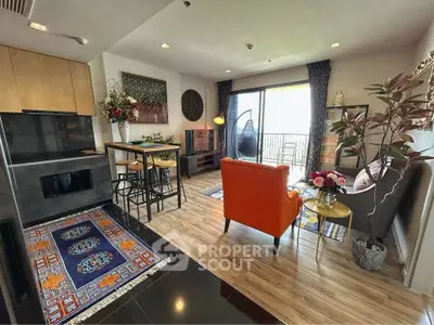 Stylish living room with modern decor and balcony access in a chic apartment.