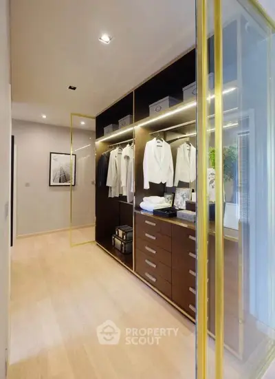 Luxurious walk-in closet with elegant wooden cabinetry and soft lighting