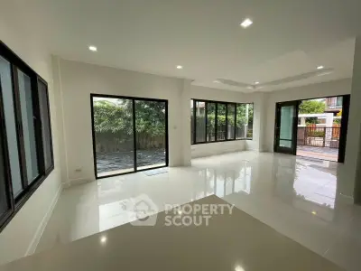 Spacious modern living room with large windows and garden view