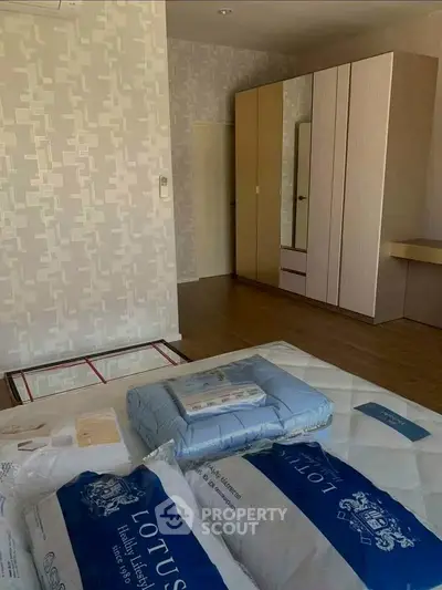 Spacious bedroom with modern wardrobe and cozy bedding in a stylish apartment.