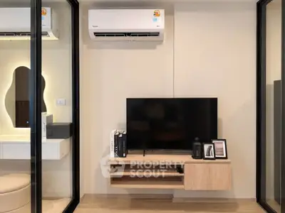 Modern living room with sleek TV setup and air conditioning unit