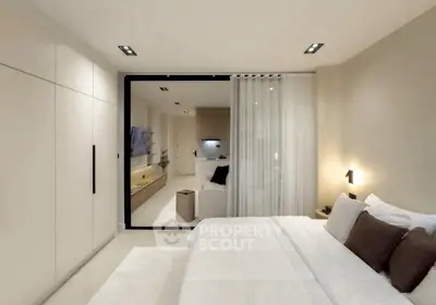 Modern bedroom with sleek design and open view to living area, featuring neutral tones and stylish lighting.