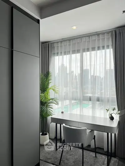 Modern study room with city view, sleek desk, and elegant decor in high-rise apartment.