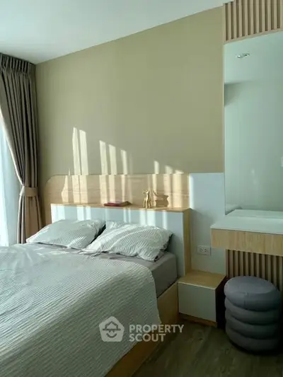 Modern bedroom with stylish decor and natural light