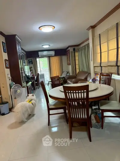 Spacious living room with elegant dining set and cozy seating area