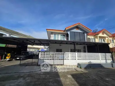 Charming two-story house with modern facade and spacious driveway in a serene neighborhood.