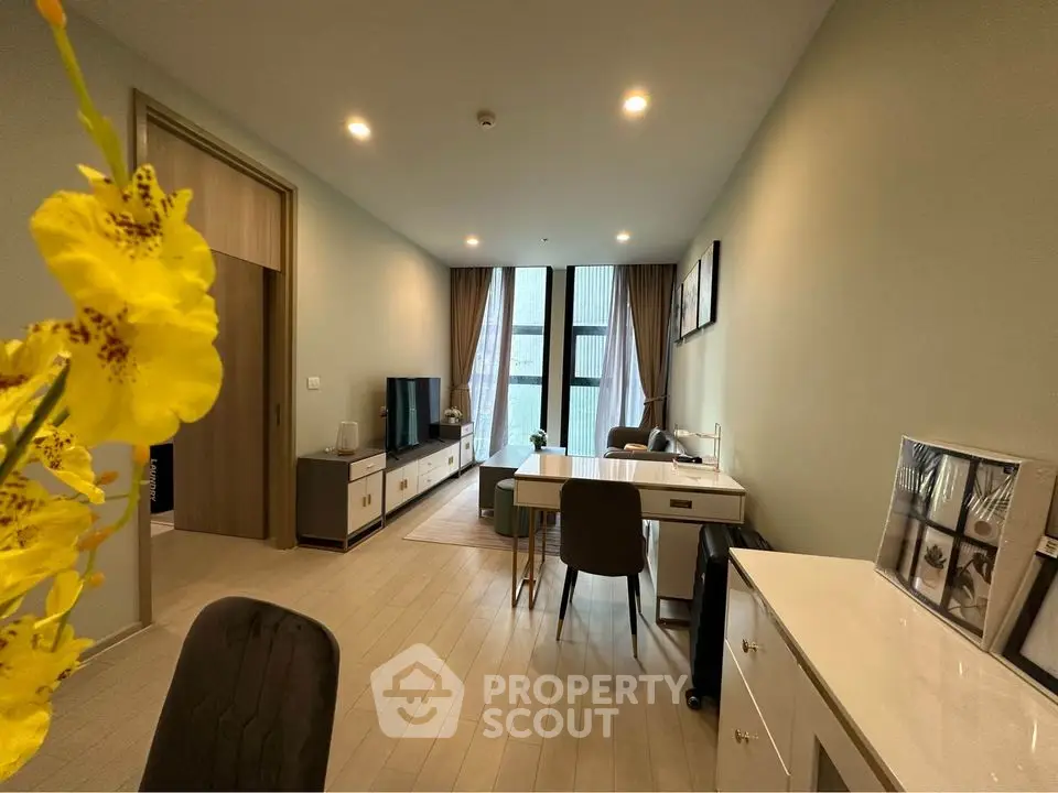 Modern living room with stylish decor and natural light, featuring a cozy seating area and elegant dining space.