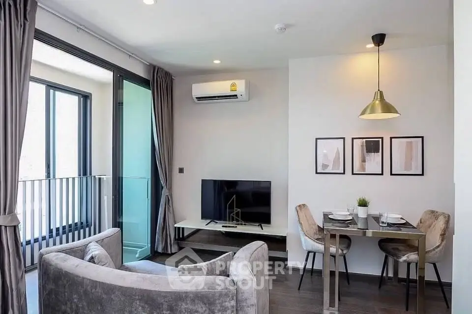 Modern living room with balcony, stylish furniture, and dining area