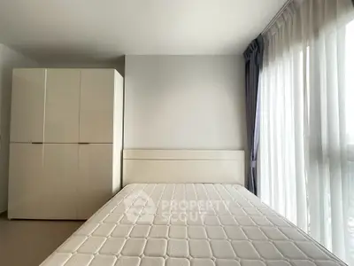 Modern minimalist bedroom with large window and wardrobe