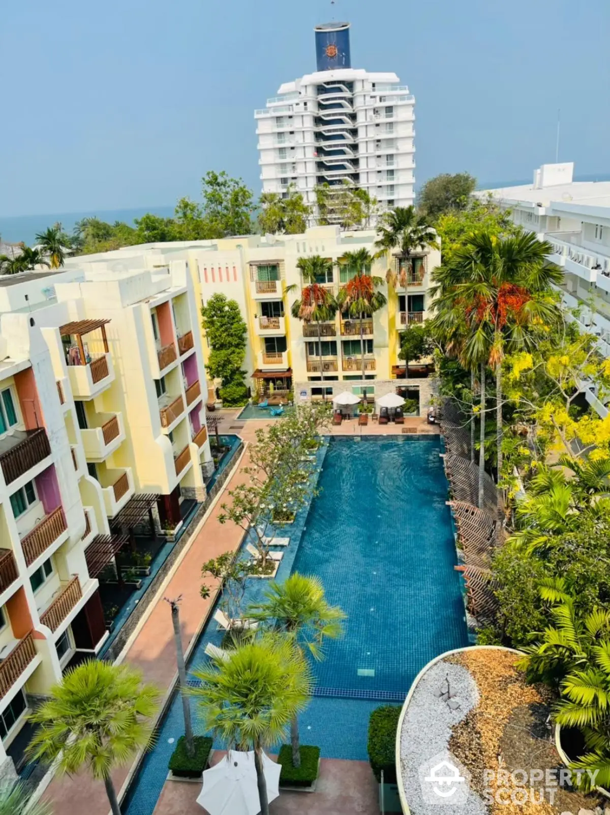 Luxurious condominium with stunning pool view and lush greenery