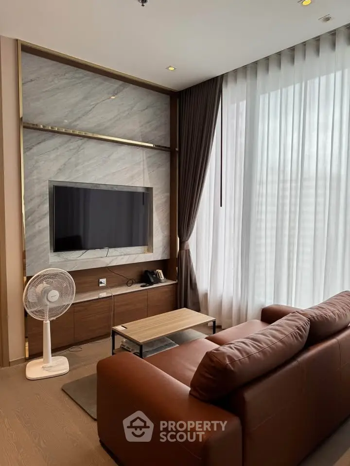 Modern living room with sleek TV setup and elegant curtains