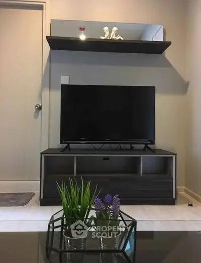 Modern living room with sleek TV stand and decorative shelf, perfect for cozy entertainment nights.