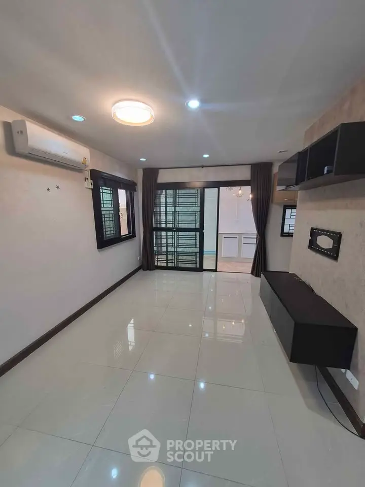 Spacious living room with modern fixtures and large windows for natural light.