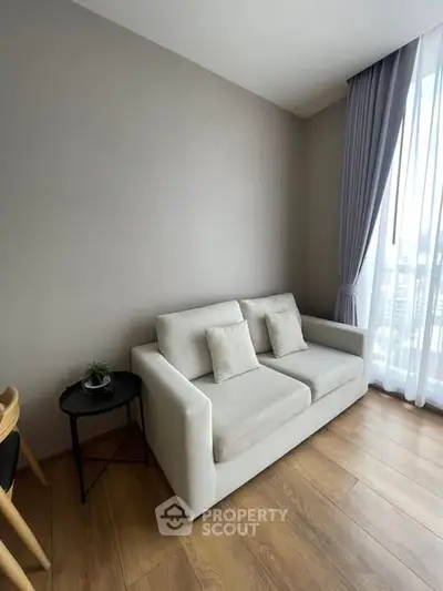 Modern living room with cozy sofa and elegant curtains in a bright apartment.