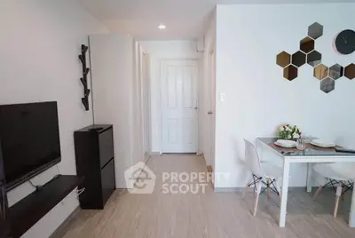 Modern living room with stylish decor and dining area in a cozy apartment.