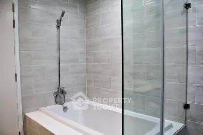 Modern bathroom with sleek bathtub and glass shower enclosure