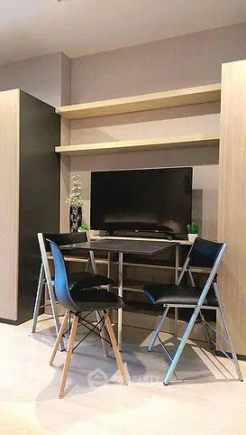 Modern living room with sleek TV setup and stylish chairs