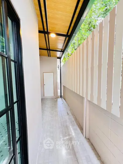 Charming narrow balcony with modern design and natural light, perfect for relaxation.