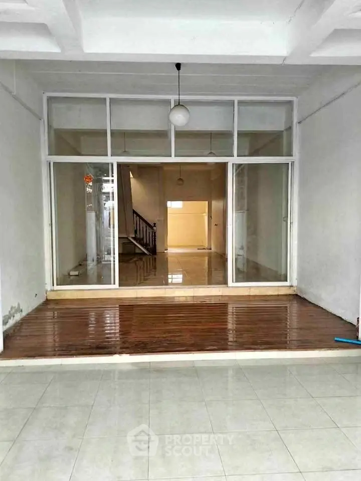 Spacious open-plan interior with large windows and modern lighting, ideal for versatile living or commercial use.