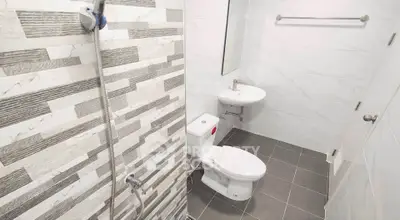 Modern bathroom with sleek tiles and compact fixtures